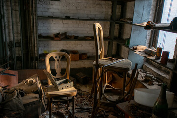 A Room in an Abandoned Building With Two Chairs Full of Debris and Very Old Objects