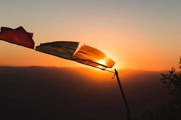 Fototapeta na wymiar tibethian flafs on air in the mountains on sunrise wind