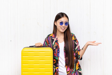 asian young woman looking happy, arrogant, proud and self satisfied, feeling like a number one....