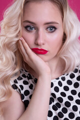 Portrait of a close-up of a young blonde woman with a severe dissatisfied look full of annoyance...