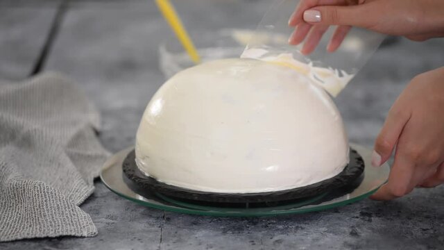 Close up of woman preparing cake with vanilla cream at home. Making Pancho Cake with Sour Cream.