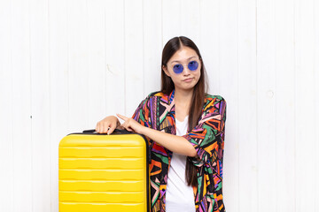 asian young woman looking impatient and angry, pointing at watch, asking for punctuality, wants to...