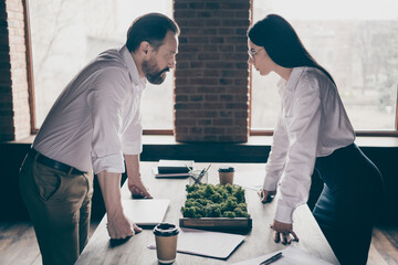 Profile photo of two colleagues have misunderstanding disagreement conflict stand in modern work station place face to face lean hands on table only one boss promotion office indoors
