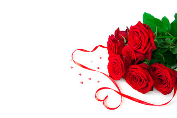Bouquet Red fresh roses isolated on white background with red ribbon. Valentine's day, Birthday, Mother's day, wedding, anniversary. Flat lay.Copy space.