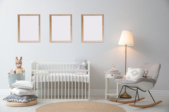 Stylish Nursery Interior With Empty Posters On Wall. Mockup For Design