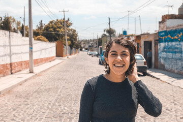 Image of beautiful young joyful woman smiling and looking at camera