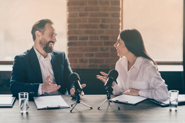 Photo of two business people corporate partners relationship answer journalist press conference...