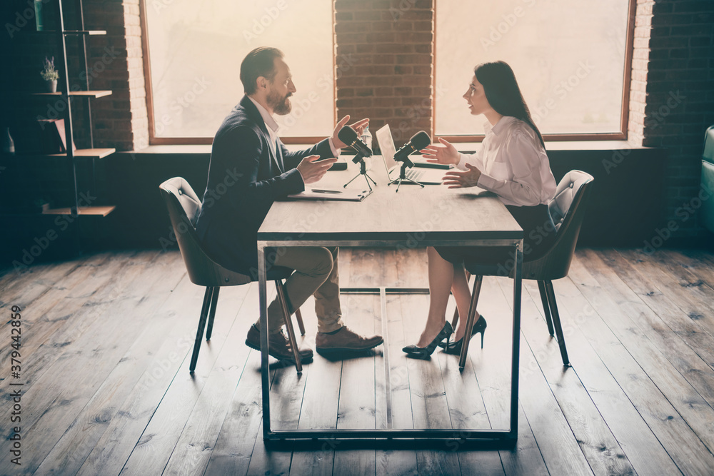 Sticker Full body profile photo of two business people man lady press conference ask answer questions speak microphone political convention sit opposite modern office indoors