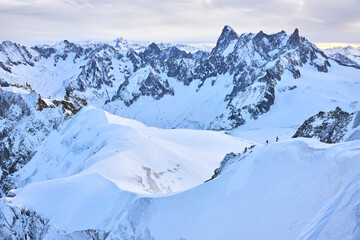 View of the high winter mountains in the evening from Aiguille du Midi. The landscape of the Alps near Chamonix in France.
