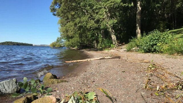 A nice view over a part of the Swedish lake Malar or Malaren. Blue sky and no clouds. Sunny day with calm water. J&auml;rf&auml;lla, Stockholm, Sweden.