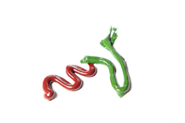 Obraz premium Red and green paint on a white background. A combination of two colors.