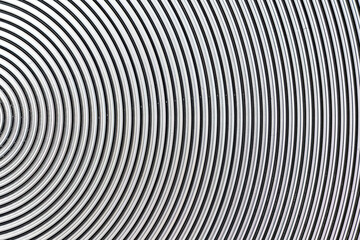 Aluminum metal surface with spiral pattern texture closeup photo background.