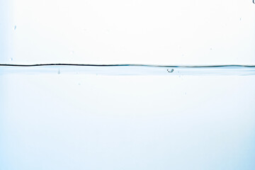 Close up of clean blue water and splash with bubbles of air isolated on white background. Diet,...