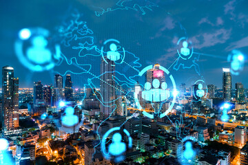 Glowing Social media icons on night panoramic city view of Bangkok, Asia. The concept of networking and establishing new connections between people and businesses. Double exposure.