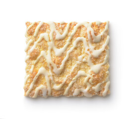 Top view of vanilla frosting drizzled square cookie