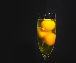 Champagne glass full of raw eggs