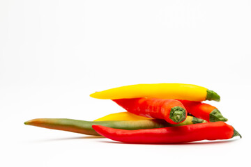 a handful of chillies with different colors isolated