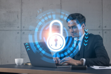 Businessman in office working with laptop, develop data protection system to diminish business risks, typing computer. Double exposure.