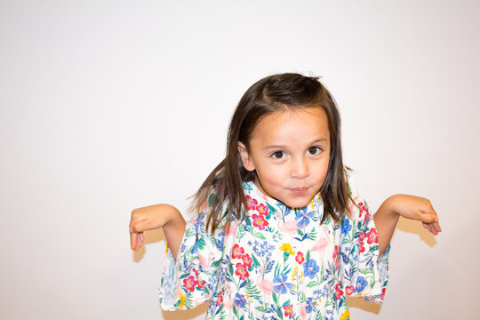 Portrait of a five year old girl making funny faces