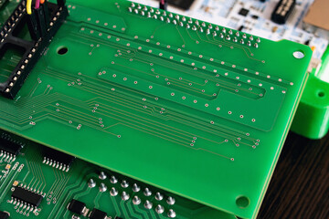 Green PCB with tracks on wooden table
