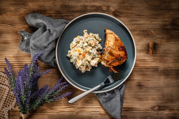 Roast chicken served with russian traditional salad.