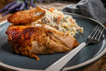 Roast chicken served with russian traditional salad.