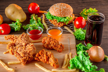 Fired chicken and chicken nuggets and spicy drumsticks on wooden background. Set of fired crispy chicken. Crispy fried chicken in  decoration with ingredient on  wooden table background