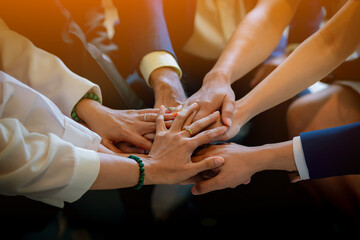 People putting their hands together. Friends with stack of hands showing unity and teamwork. Business people join hand together during their meeting. Team work concept. Business people joining hands.
