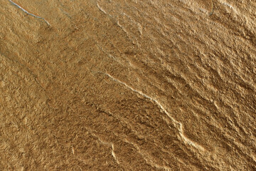 Golden stone texture as a background.