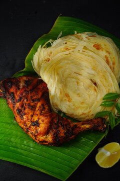 Kerala Parotta or Porotta with grilled chicken, selective focus