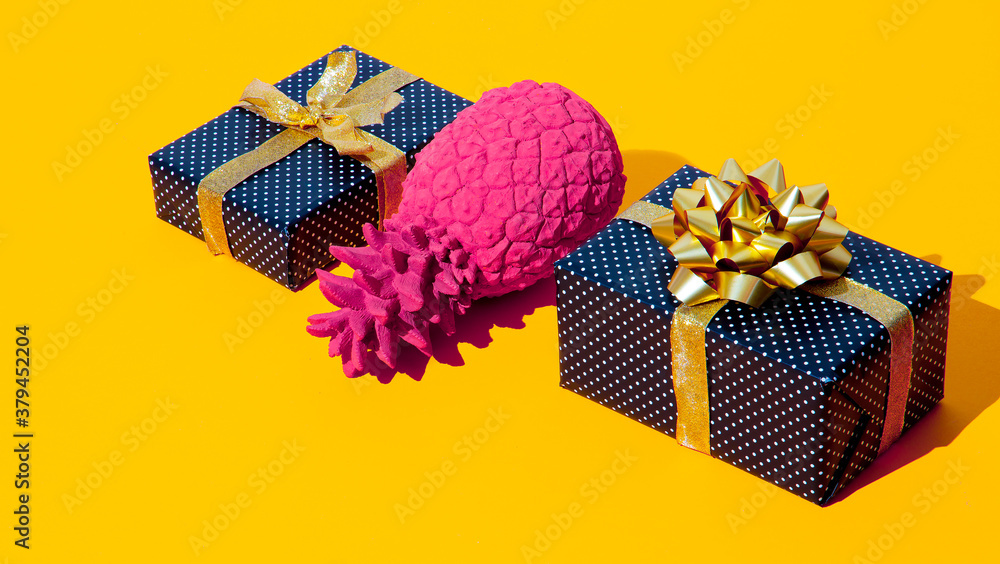 Poster Gift box and fake pineapple on yellow background. Minimal isometric design. Holidays and shopping concept