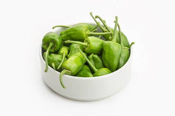 Fresh Padron pepper in bowl on white background. Capsicum annuum