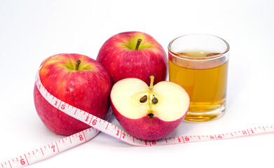 apple cider vinegar,apple and apple juice with tape measure on white background, healty food, drink for weight control in summer.
