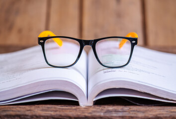 Glasses on the book blurred background