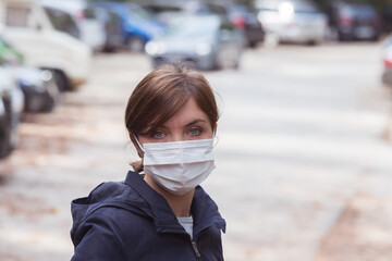 Flue and corona safety concept. Woman wearing face mask to protect herself, outdoors