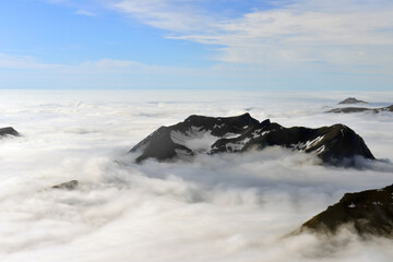 Mountain peaks among dense clouds. Norway