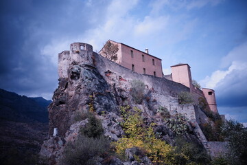 Fototapeta na wymiar Mystisches Kloster auf einem Fels, mitten in den Bergen mit Gewitterwolken