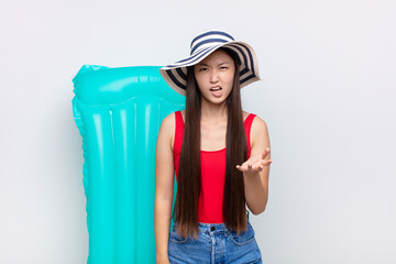 asian young woman looking angry, annoyed and frustrated screaming wtf or what‚Äôs wrong with...