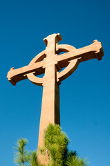 Wood Cross at Monastery backed by Blue sky