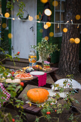 Assorted Italian food table setting in the garden, selective focus