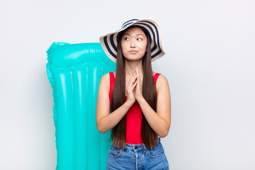 asian young woman scheming and conspiring, thinking devious tricks and cheats, cunning and...