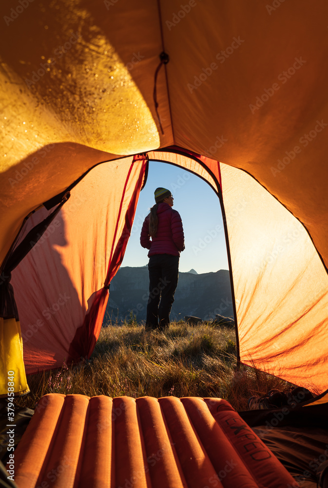 Poster enjoying the view from the campsite in the mountains during a summers sunrise.