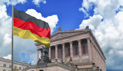 flagpole and german flag in front of german architecture building