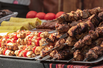 Culinary buffet with takeaway healthy food - meat, pepper, spices, grilled vegetables. Fish and meat on the street, food market, festival, event. Kitchen in the open air.