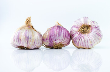 Three garlic freshly harvested from the garden