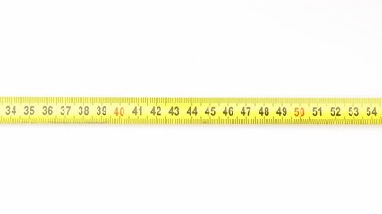 Extending measuring tape on white background
