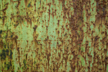 rust texture on metal door with green paint