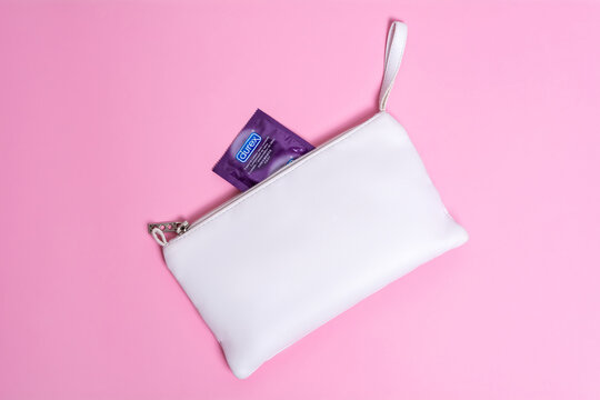 Kyiv, Ukraine - 14 July 2020: Durex  Elite condom near white cosmetic bag. Health and safe sex.