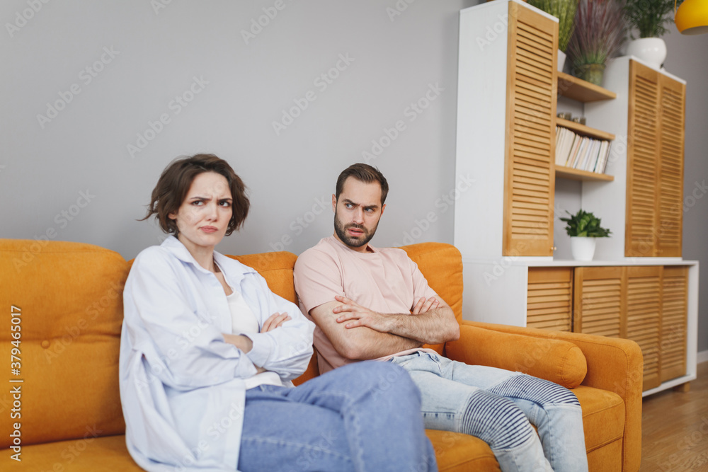 Wall mural displeased dissatisfied perplexed puzzled offended young couple two friends man woman 20s in casual 