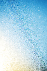 Abstract blurred bokeh background with water rain drops on window glass.